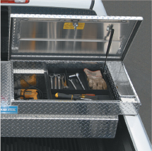 An open Adrian Steel pickup truck storage box full of tools installed on a pickup