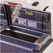 An open Adrian Steel tool box installed on a pickup truck