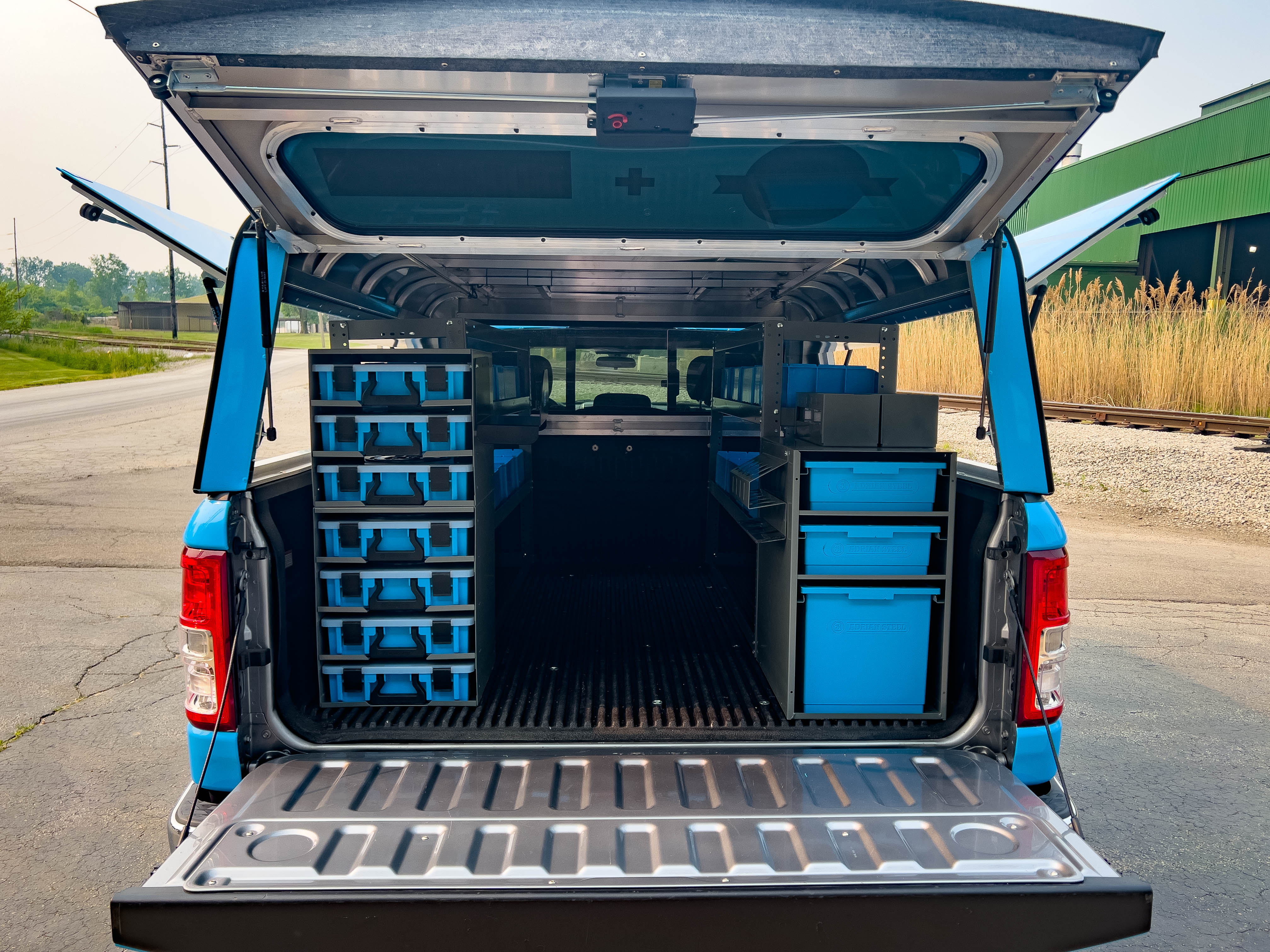 rear view of a pickup upfitted with an Adrian Steel plumber truck storage package